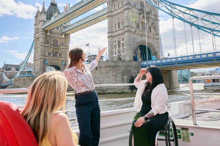 Live guided River Thames tour passing directly beside Tower Bridge